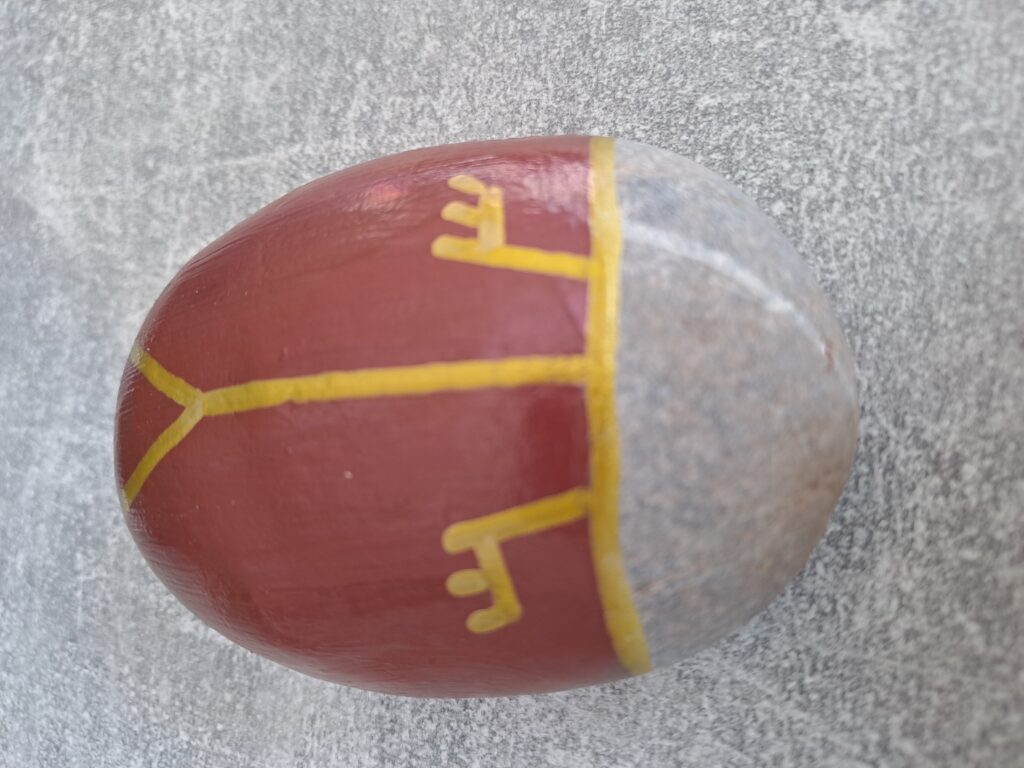Maikäfer auf Stein malen, hier werden die fächerartigen Fühler mit dem goldenen Acrylstift aufgemalt